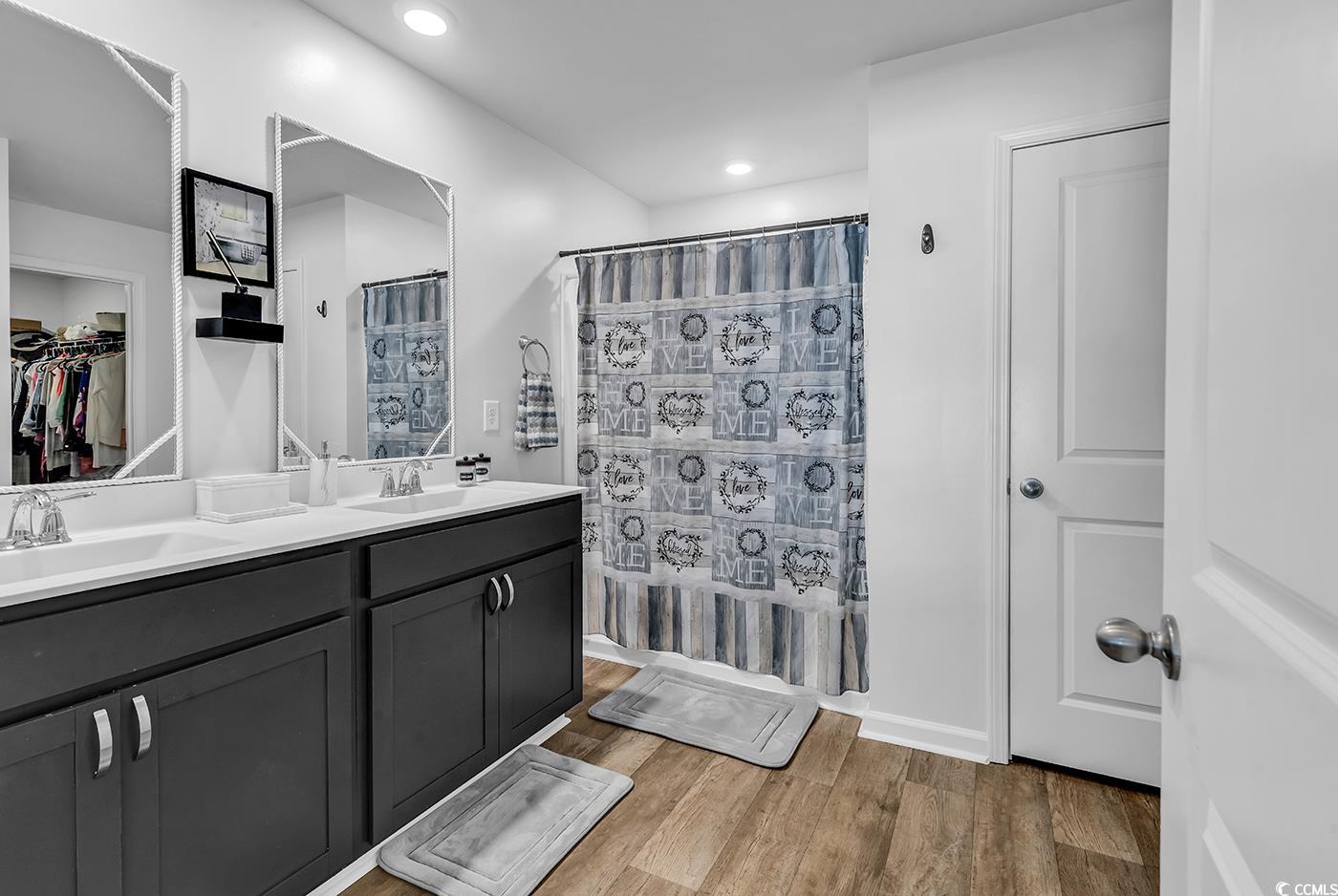 164 Seasons Trace Loop Longs, SC 29568 - Photo 20 of 40 Full bath featuring a spacious closet, double vanity, light wood-style flooring, curtained shower, and recessed lighting
