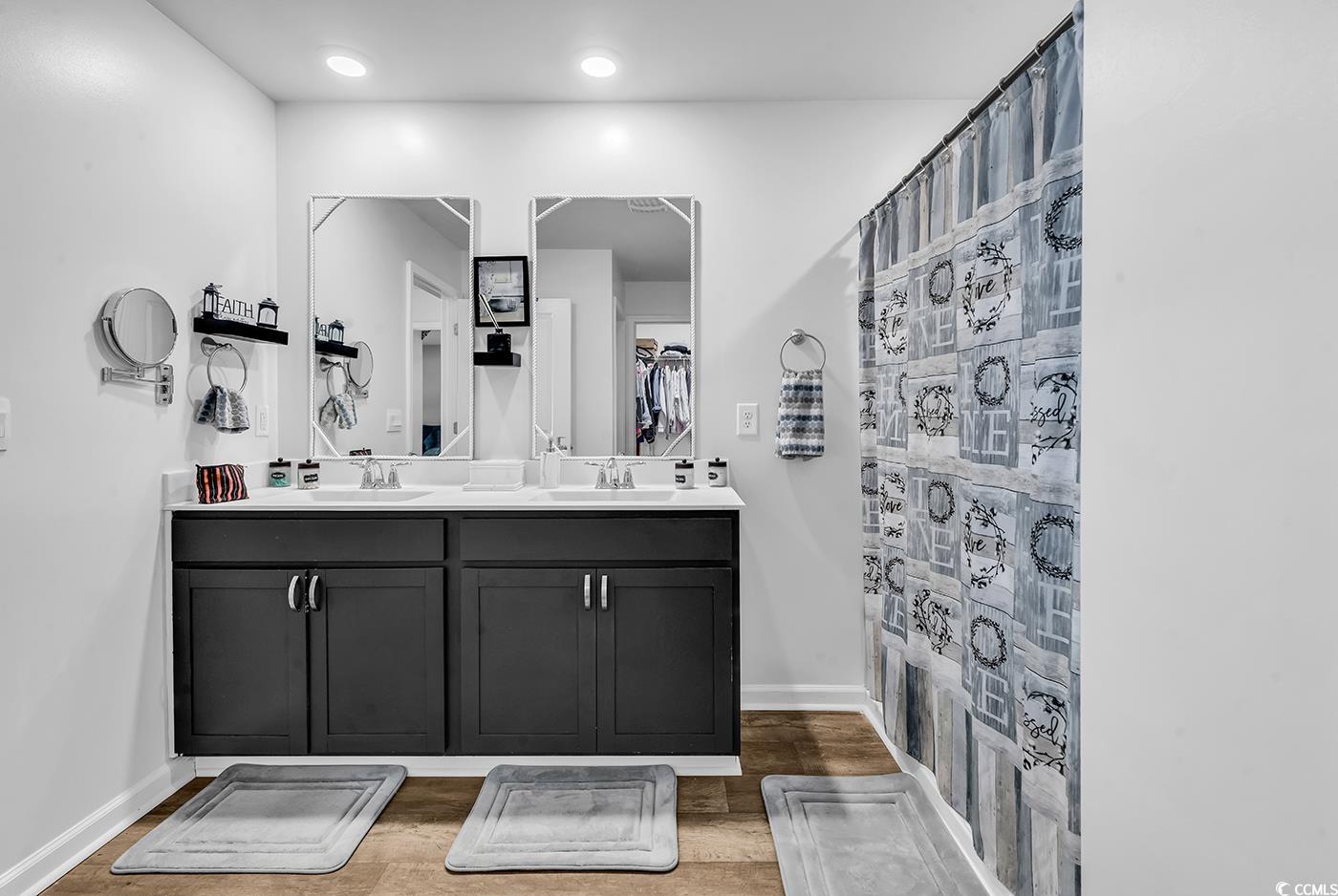 164 Seasons Trace Loop Longs, SC 29568 - Photo 21 of 40 Bathroom with a shower with curtain, double vanity, and wood finished floors