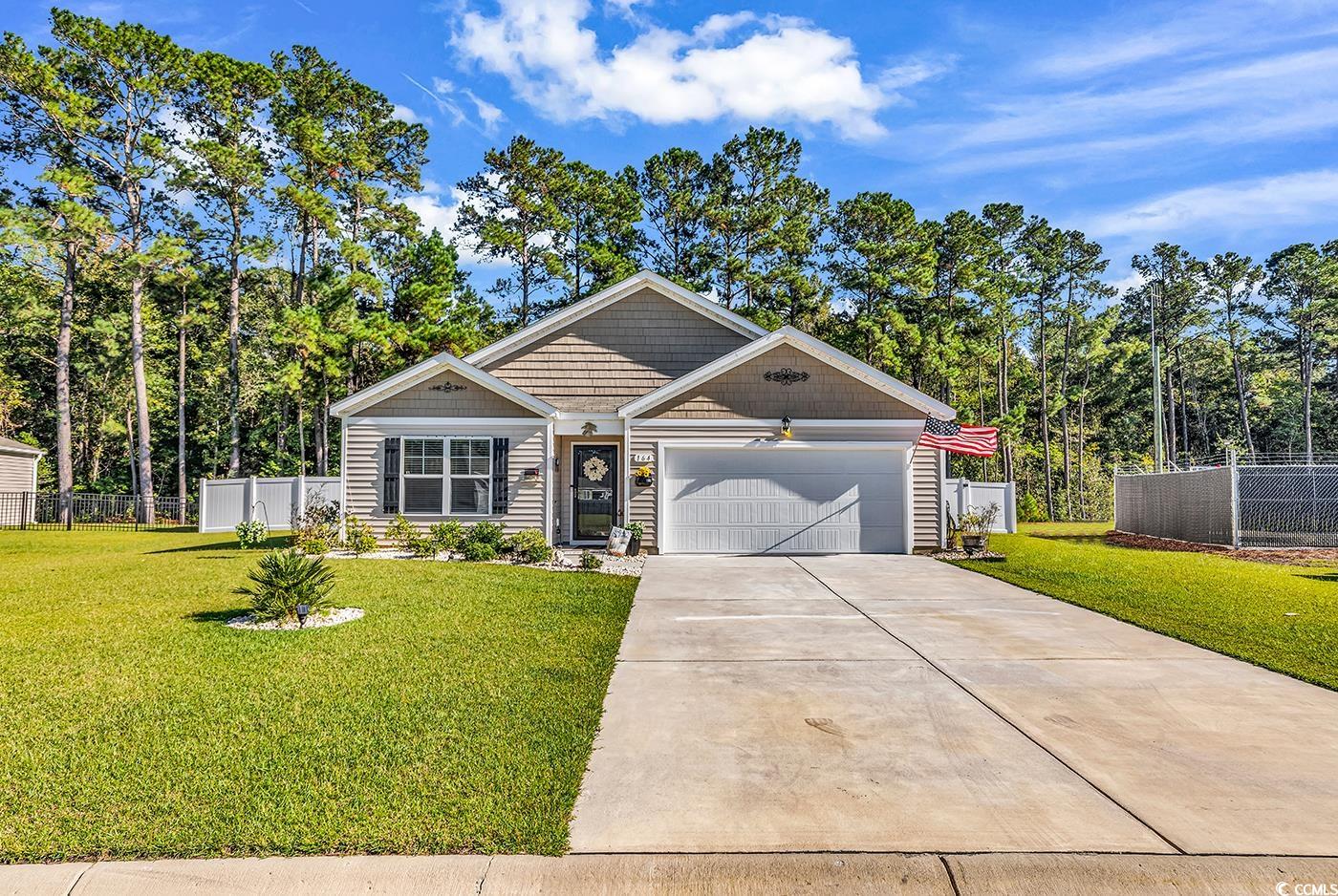 164 Seasons Trace Loop Longs, SC 29568 - Photo 3 of 40 View of front facade with concrete driveway, an attached garage, and view of wooded area