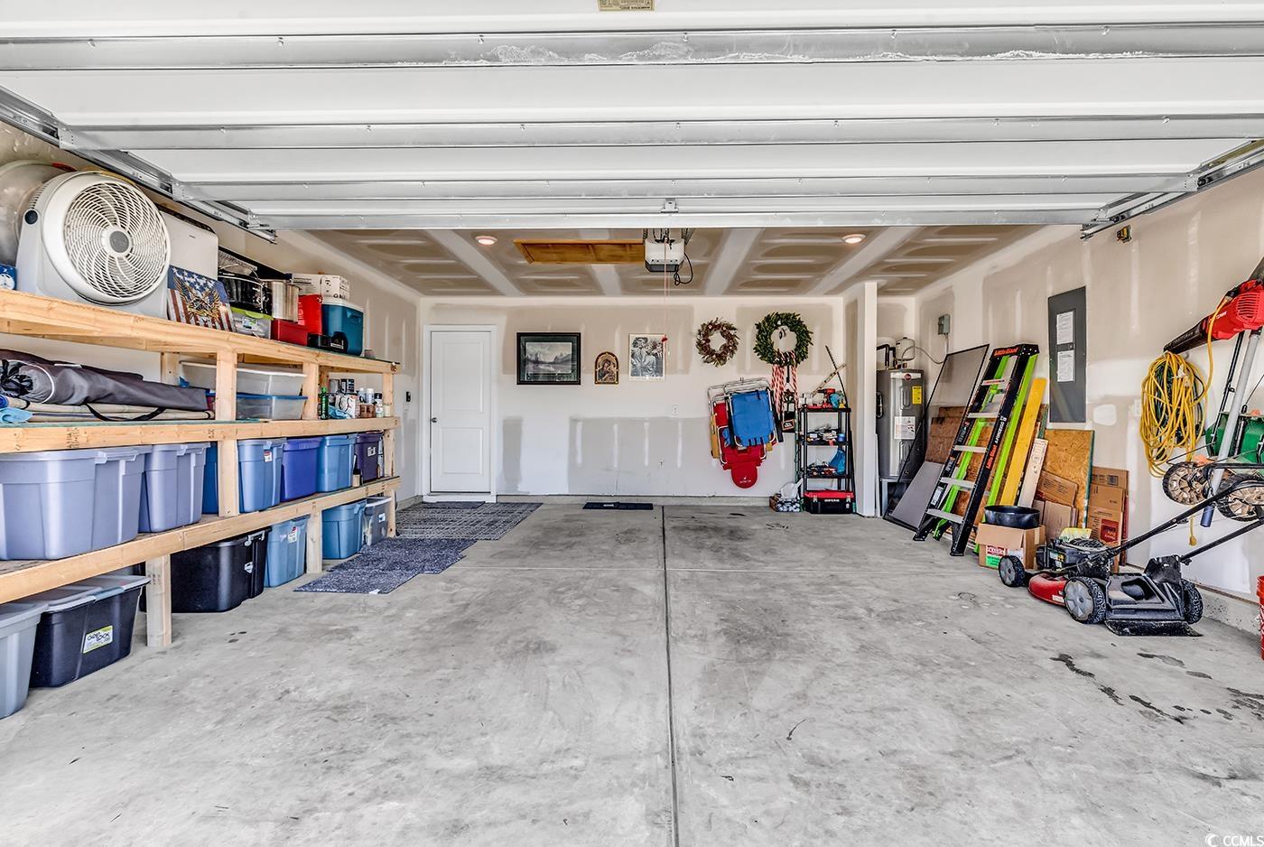 164 Seasons Trace Loop Longs, SC 29568 - Photo 36 of 40 Garage with water heater and a garage door opener