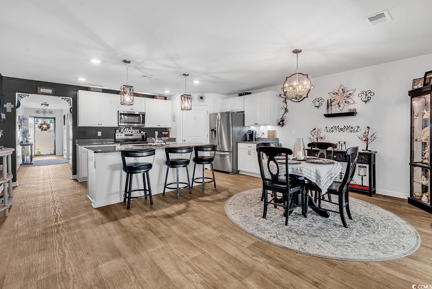 164 Seasons Trace Loop Longs, SC 29568 - Photo 10 of 40 Dining area featuring recessed lighting, a chandelier, and light wood-style flooring