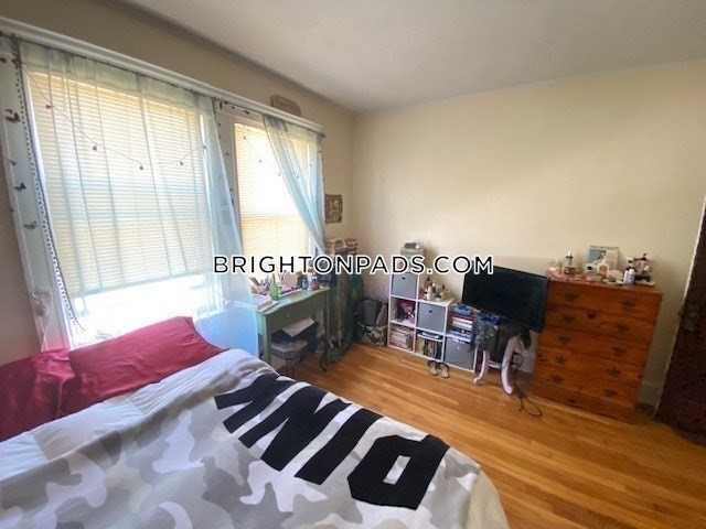 75 Claymoss Road, Unit 1 Boston, MA 02135 - Photo 12 of 25 a bedroom with furniture and a wooden floor