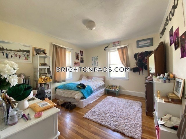 75 Claymoss Road, Unit 1 Boston, MA 02135 - Photo 15 of 25 a bedroom with furniture and a flat screen tv