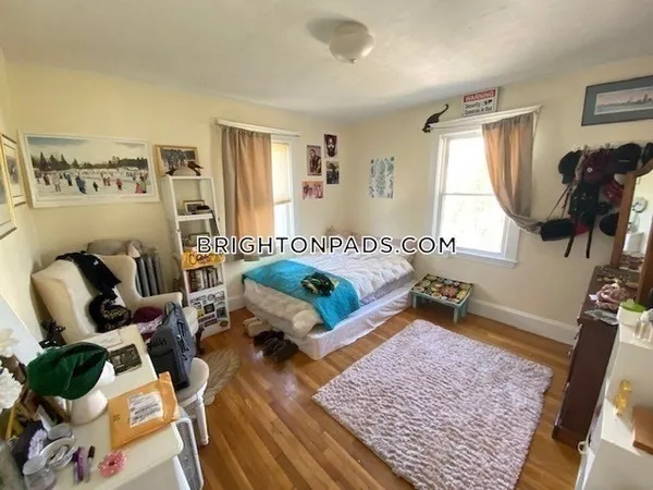 a bedroom with furniture and a window