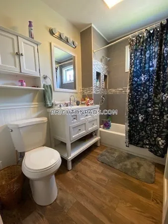 a bathroom with a toilet sink and shower