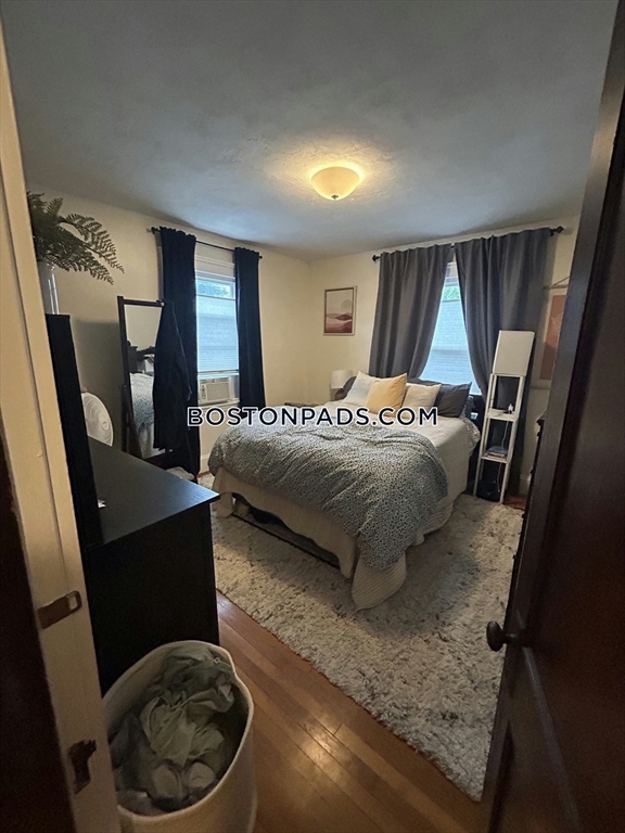 75 Claymoss Road, Unit 1 Boston, MA 02135 - Photo 21 of 25 a bedroom with a bed and wooden floor