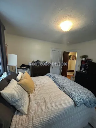 a bedroom with a bed and lamp
