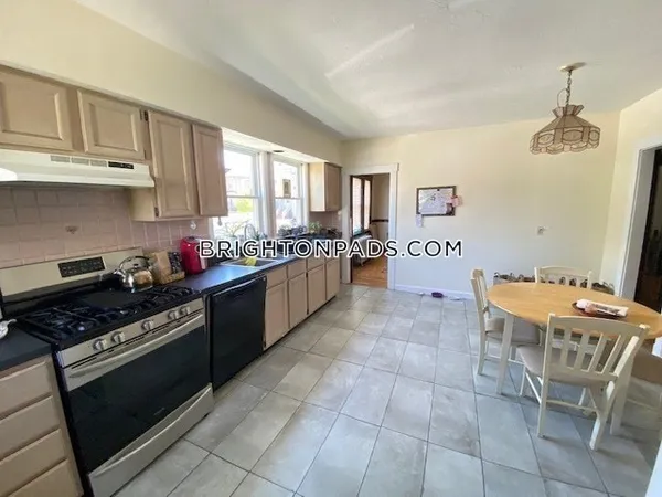 a kitchen with stainless steel appliances granite countertop a stove a sink dishwasher and a refrigerator