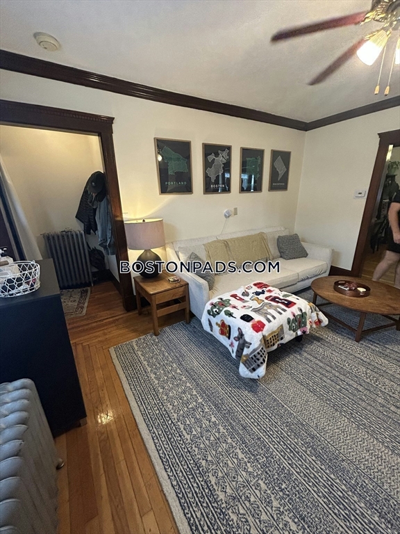 75 Claymoss Road, Unit 1 Boston, MA 02135 - Photo 4 of 25 a bedroom with a bed and wooden floor