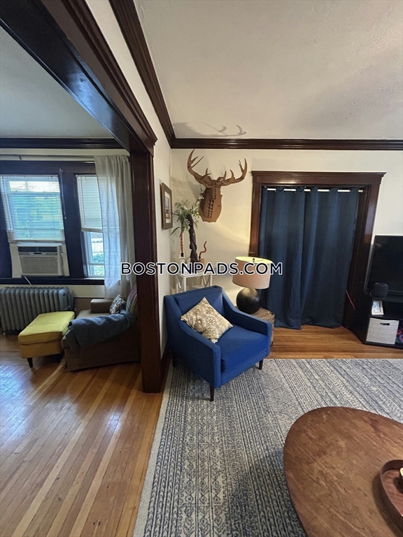 75 Claymoss Road, Unit 1 Boston, MA 02135 - Photo 6 of 25 a living room with furniture and wooden floor