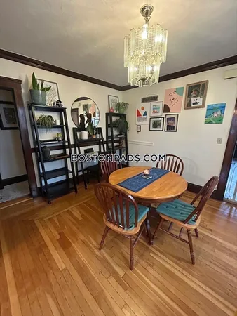 a bedroom with furniture a rug and wooden floor