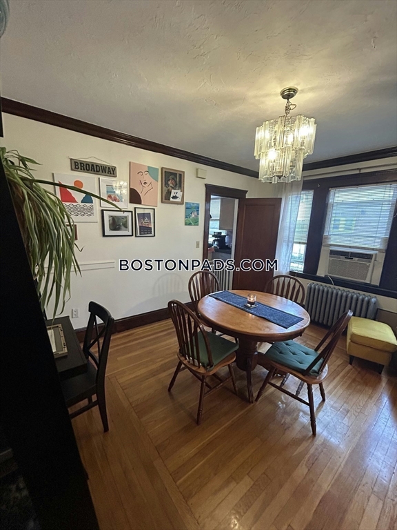 75 Claymoss Road, Unit 1 Boston, MA 02135 - Photo 9 of 25 a view of a dining room with furniture and wooden floor