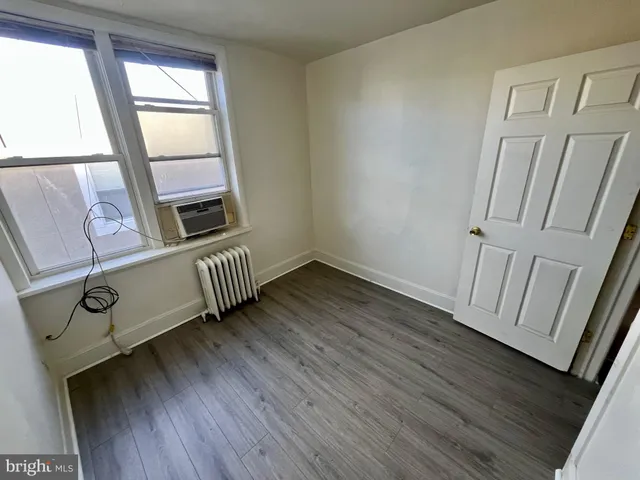a view of a hardwood floor and wardrobe
