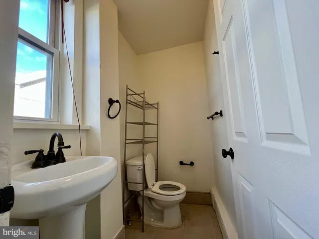 a bathroom with a toilet sink and shower
