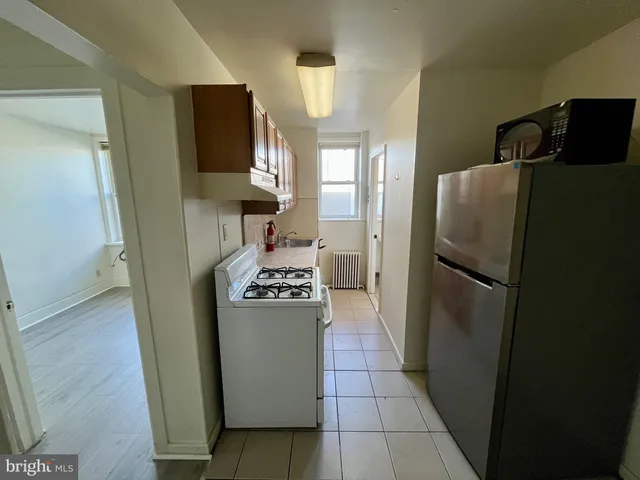 a kitchen with stainless steel appliances granite countertop a refrigerator and a stove