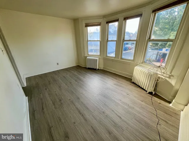 a view of front door with furniture and a window