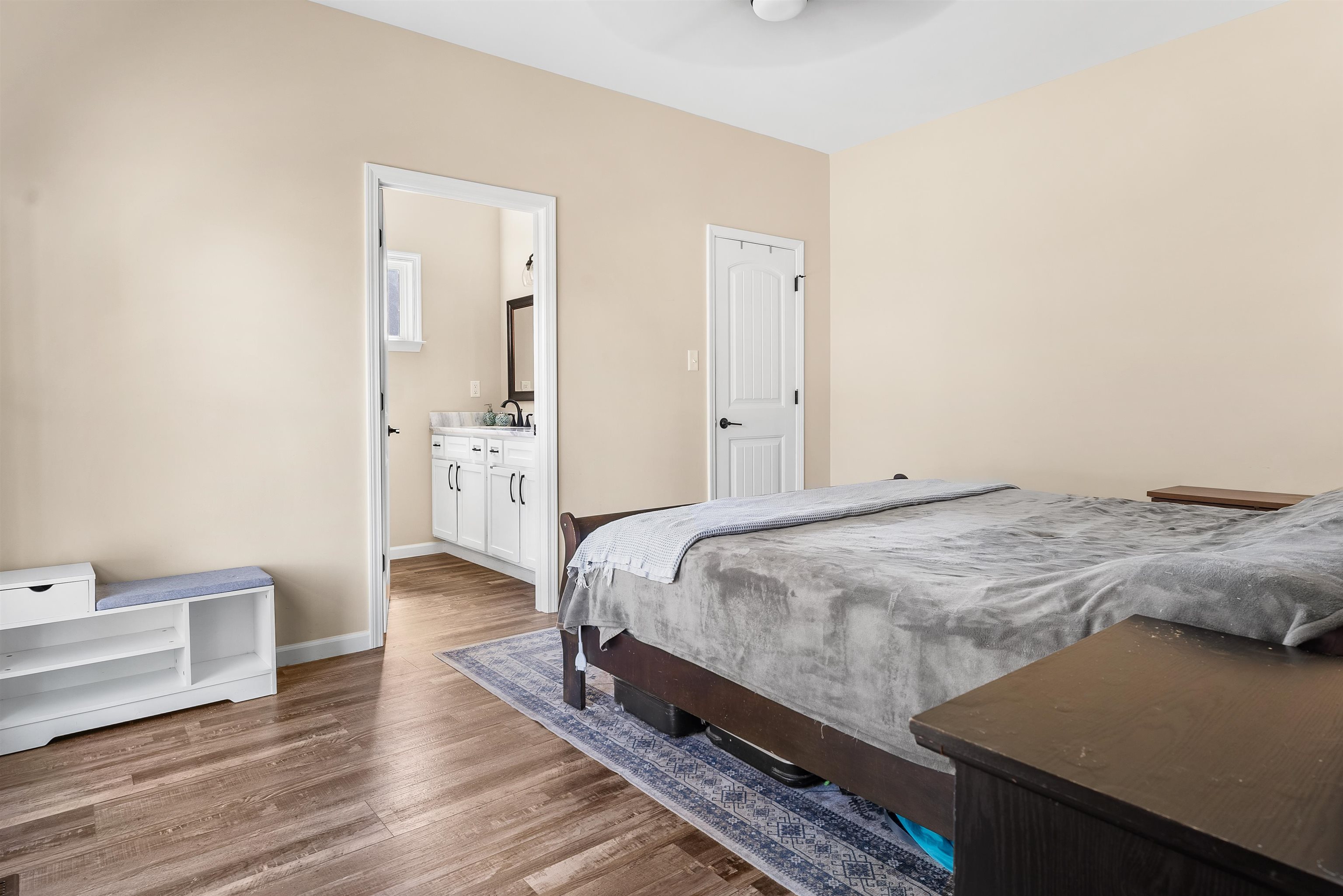 212 South Tipton Street Covington, TN 38019 - Photo 10 of 27 a bedroom with a bed and wooden floor