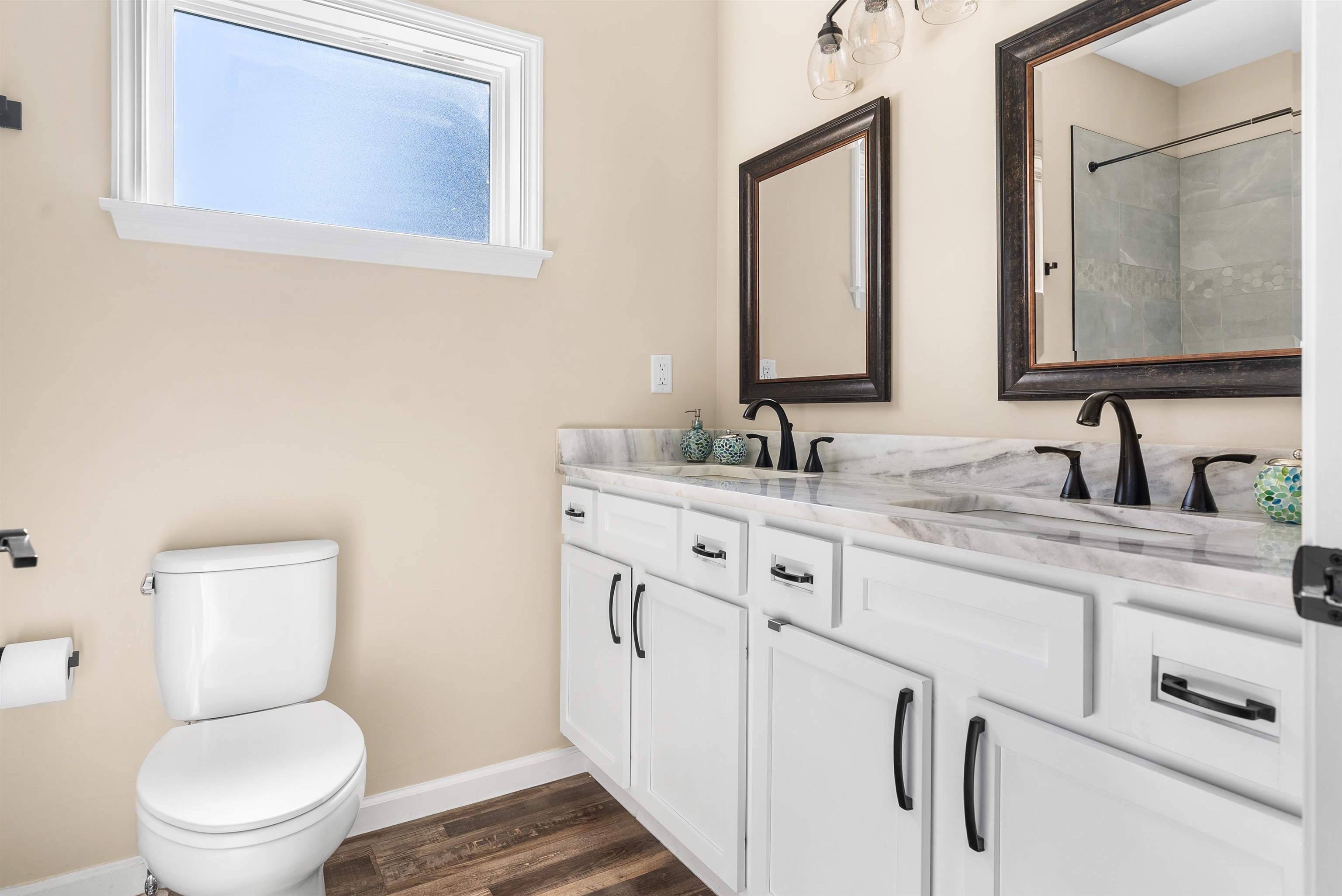212 South Tipton Street Covington, TN 38019 - Photo 12 of 27 a bathroom with a granite countertop toilet sink and mirror