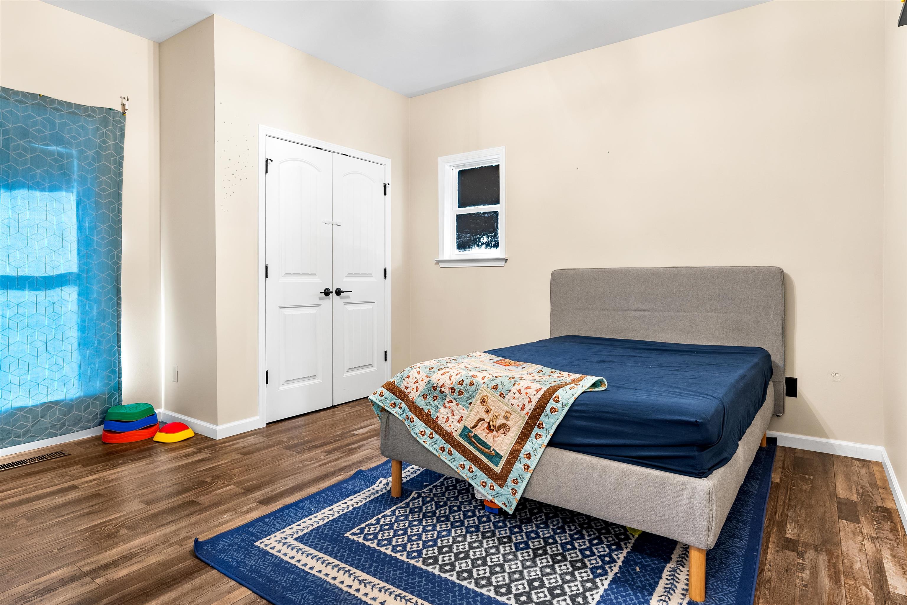 212 South Tipton Street Covington, TN 38019 - Photo 13 of 27 a living room with a couch and a table with wooden floor