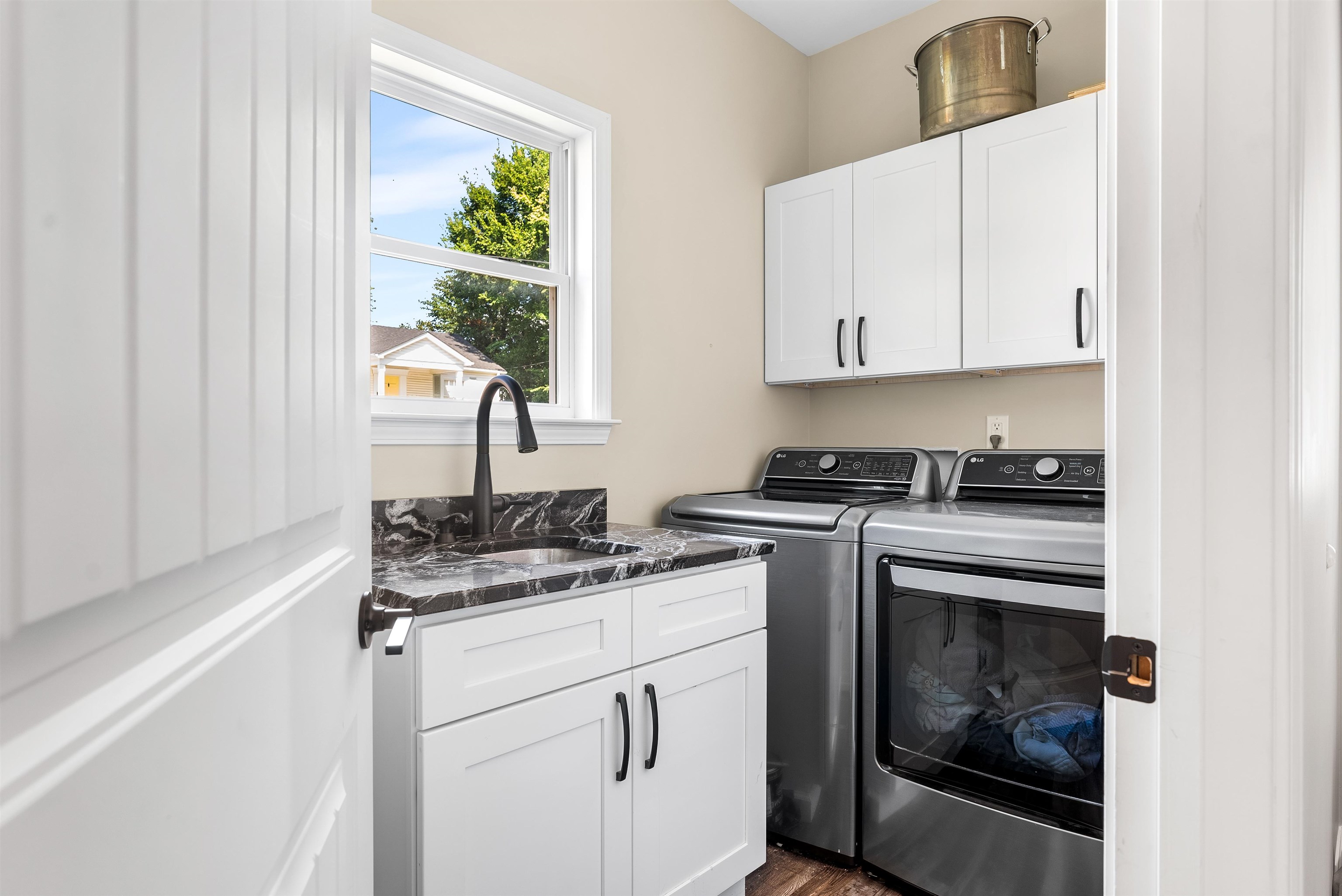 212 South Tipton Street Covington, TN 38019 - Photo 16 of 27 a kitchen with a stove a sink and a window