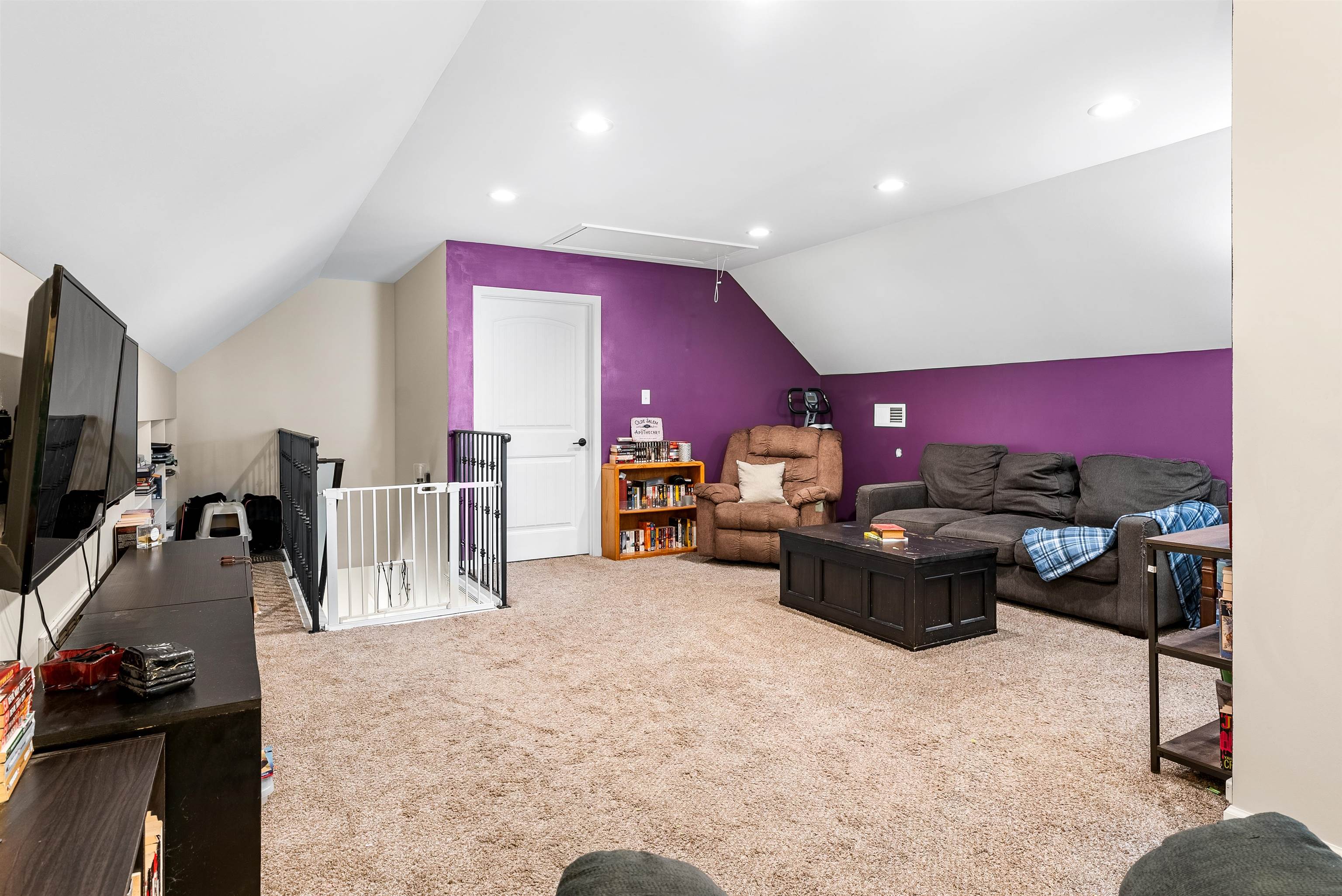 212 South Tipton Street Covington, TN 38019 - Photo 19 of 27 a living room with furniture a flat screen tv and a view of kitchen