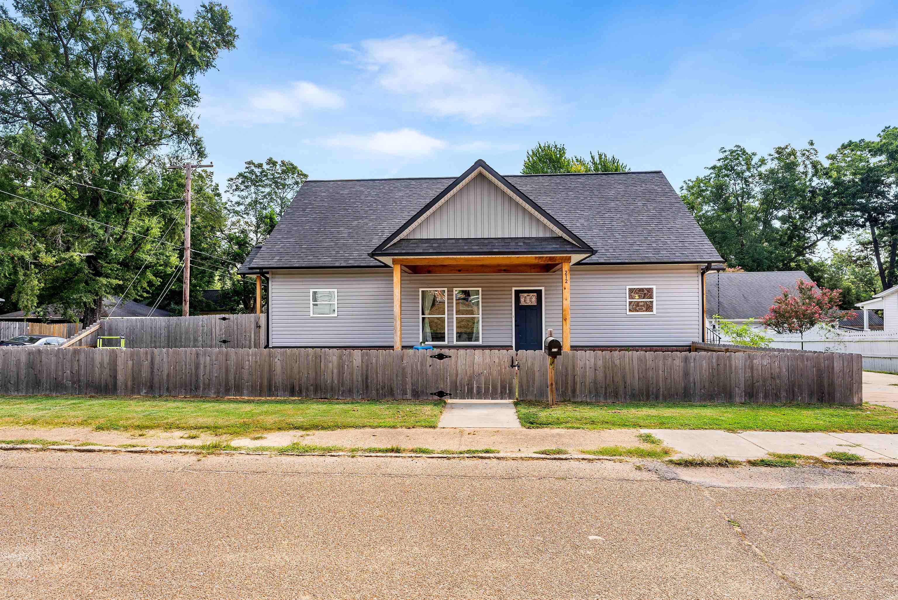 212 South Tipton Street Covington, TN 38019 - Photo 3 of 27 a view of a house with a swimming pool and a yard