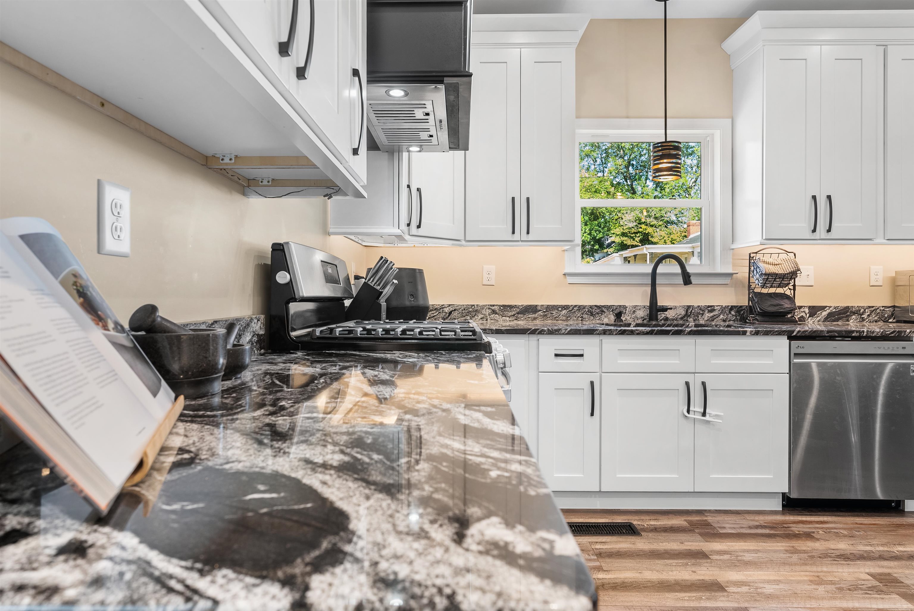 212 South Tipton Street Covington, TN 38019 - Photo 8 of 27 a kitchen with stainless steel appliances granite countertop a sink stove and cabinets