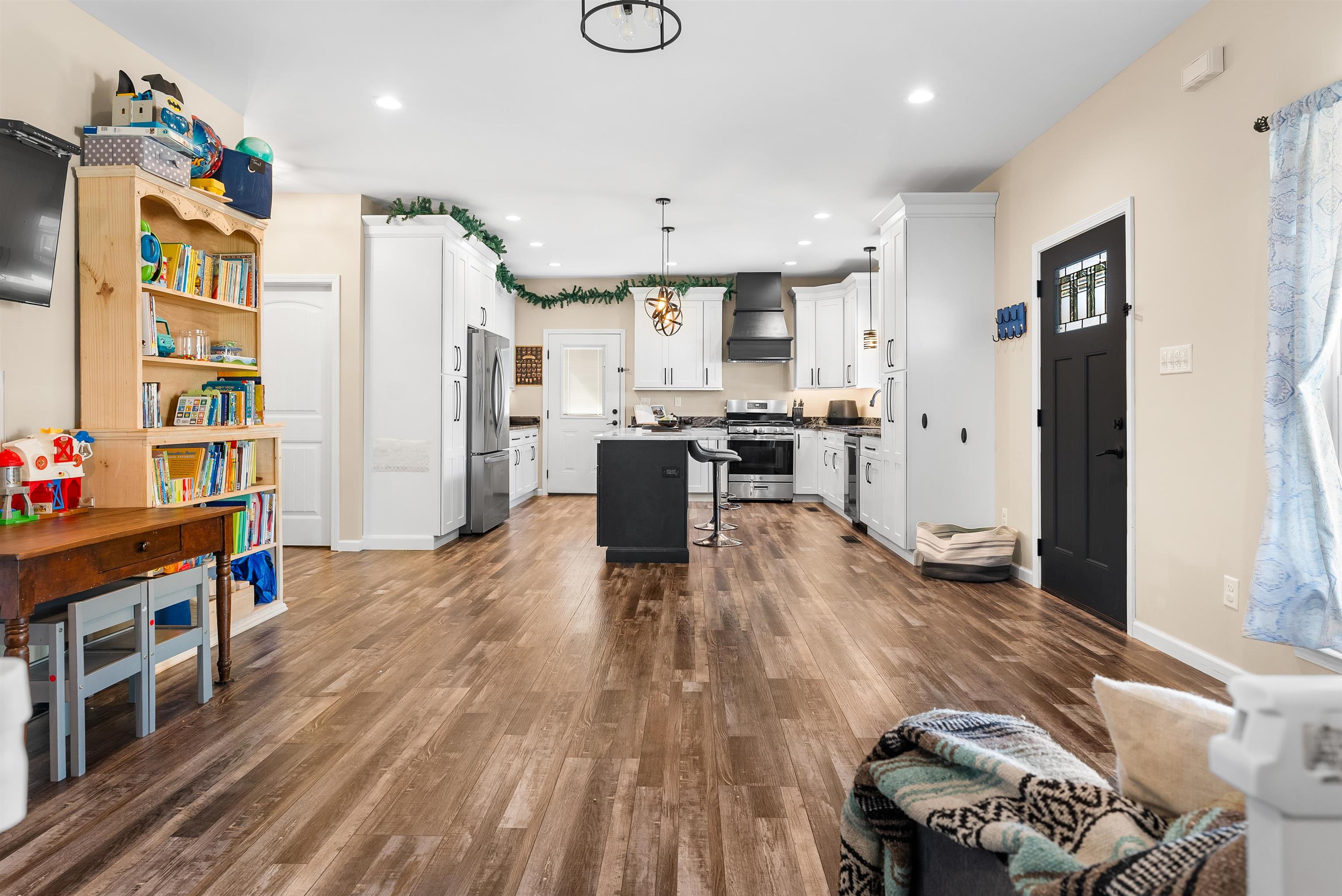 212 South Tipton Street Covington, TN 38019 - Photo 25 of 27 a kitchen with stainless steel appliances wooden floor and large windows