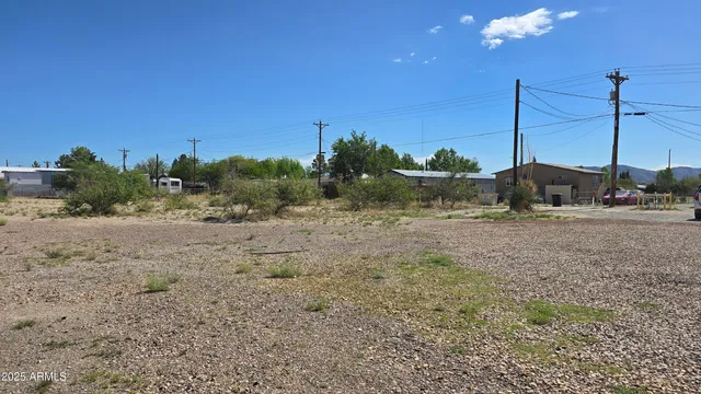 a view of a yard with wooden fence