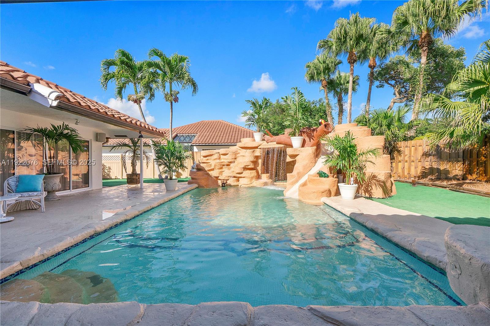 a swimming pool with outdoor seating and yard