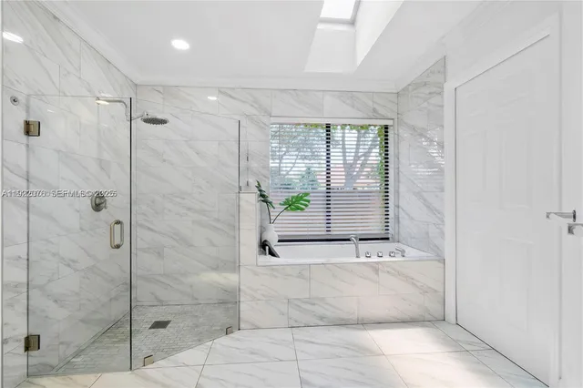 a bathroom with a bathtub and shower