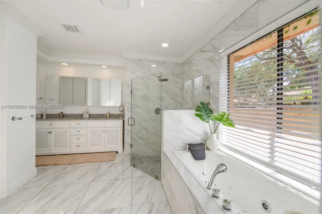 a bathroom with a tub sink and mirror