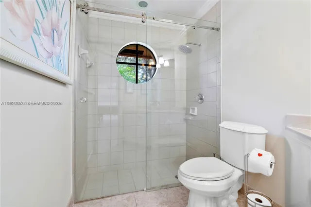 a bathroom with a toilet and a shower