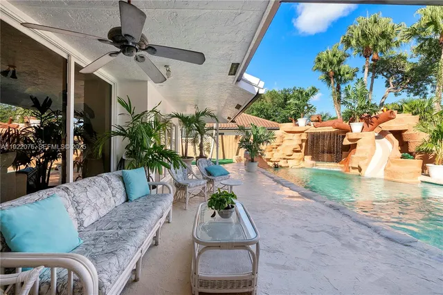 a living room with patio furniture and a potted plant