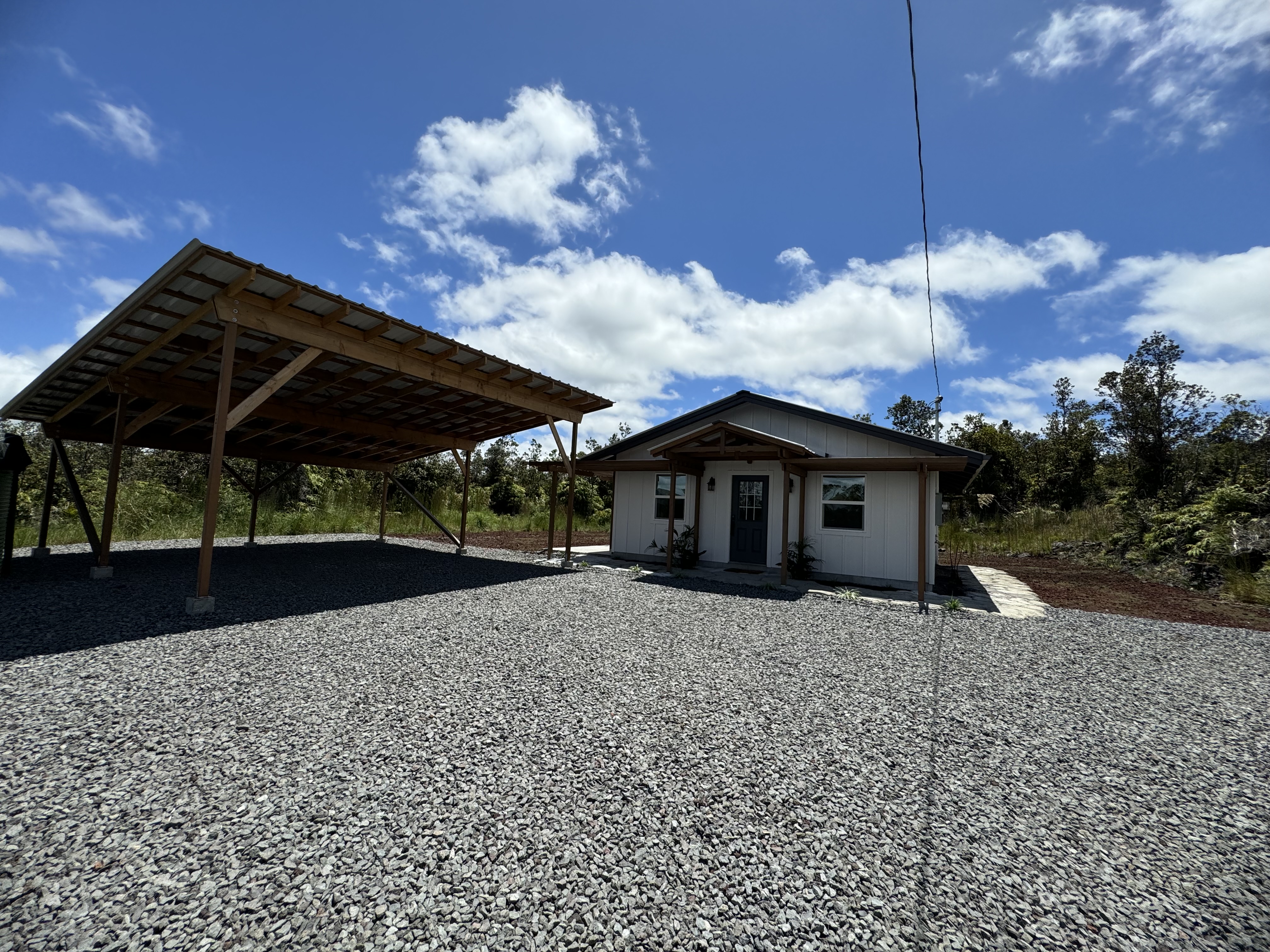 11-3229 Volcano Road Volcano, HI 96771 - Photo 3 of 30 a front view of a house with a yard and garage