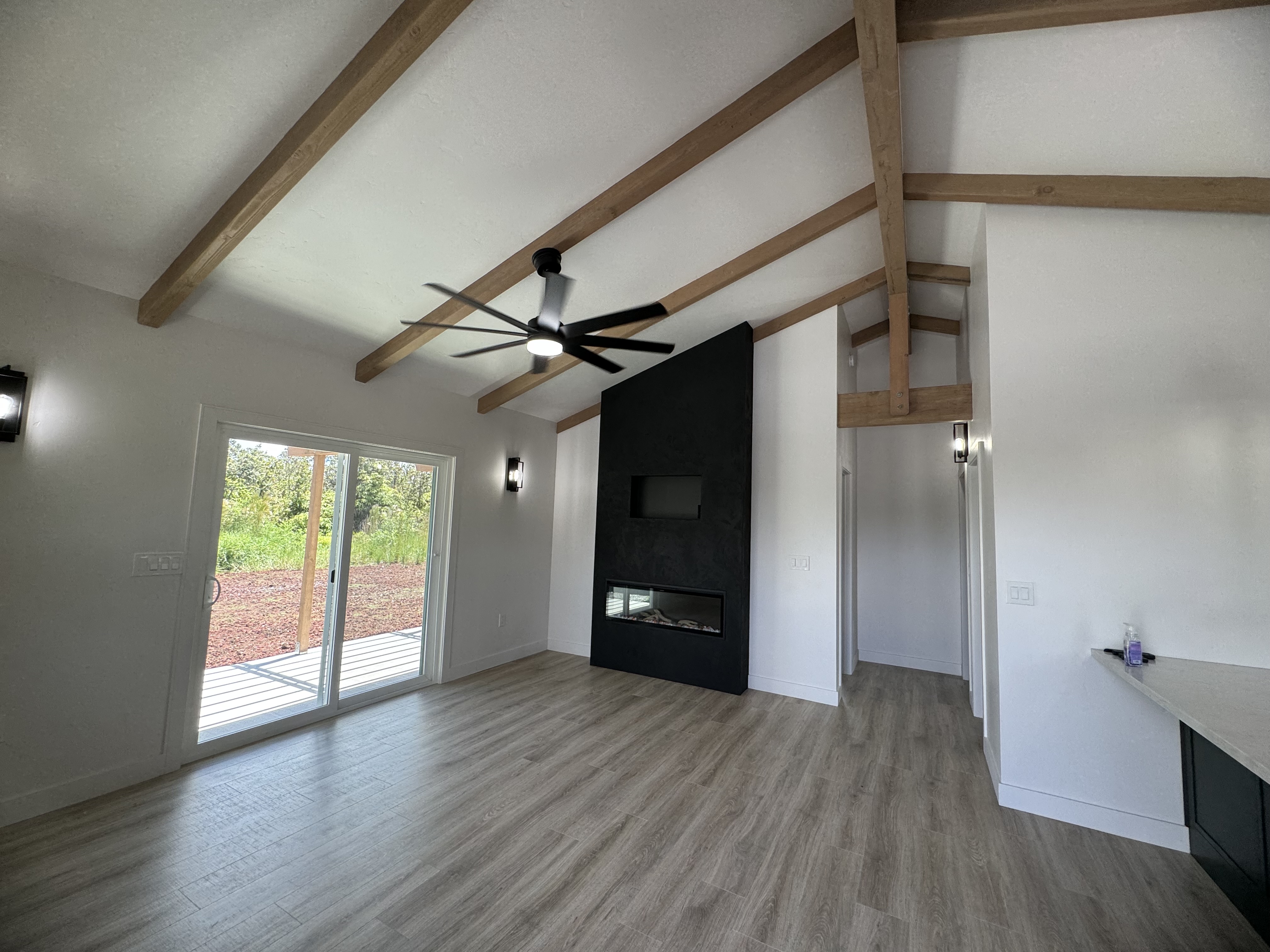 11-3229 Volcano Road Volcano, HI 96771 - Photo 4 of 30 a view of an empty room with wooden floor and a window