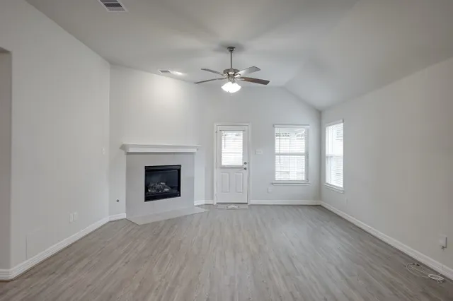 wooden floor chandelier and windows in a room