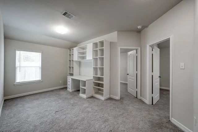 a view of room with windows and cabinet