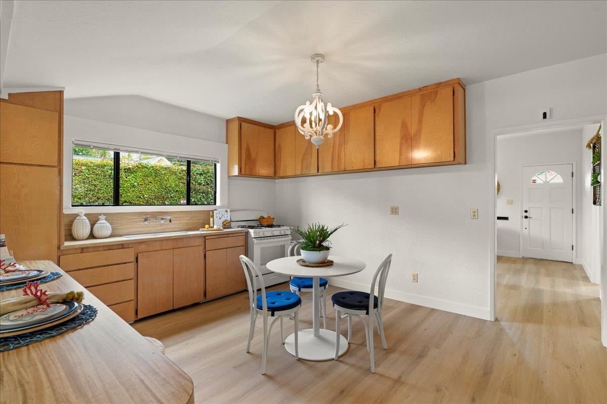 214 Rigg Street Santa Cruz, CA 95060 - Photo 11 of 32 a kitchen with a dining table chairs and a refrigerator