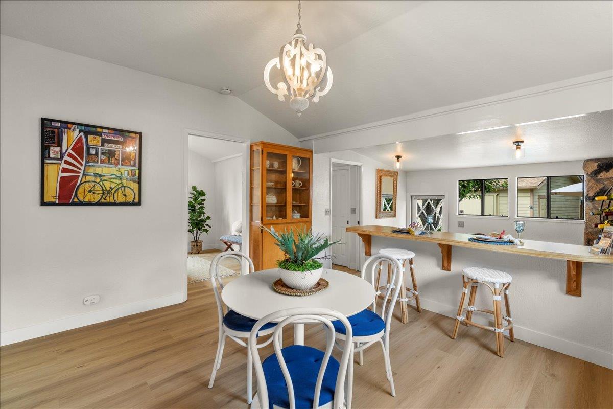 214 Rigg Street Santa Cruz, CA 95060 - Photo 12 of 32 a view of a dining room with furniture wooden floor and chandelier