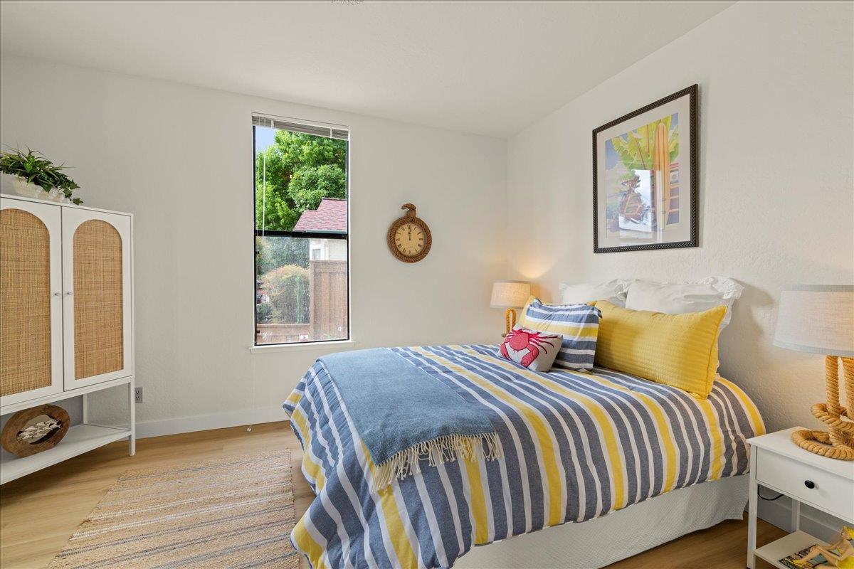 214 Rigg Street Santa Cruz, CA 95060 - Photo 16 of 32 a bedroom with bed and wooden floor