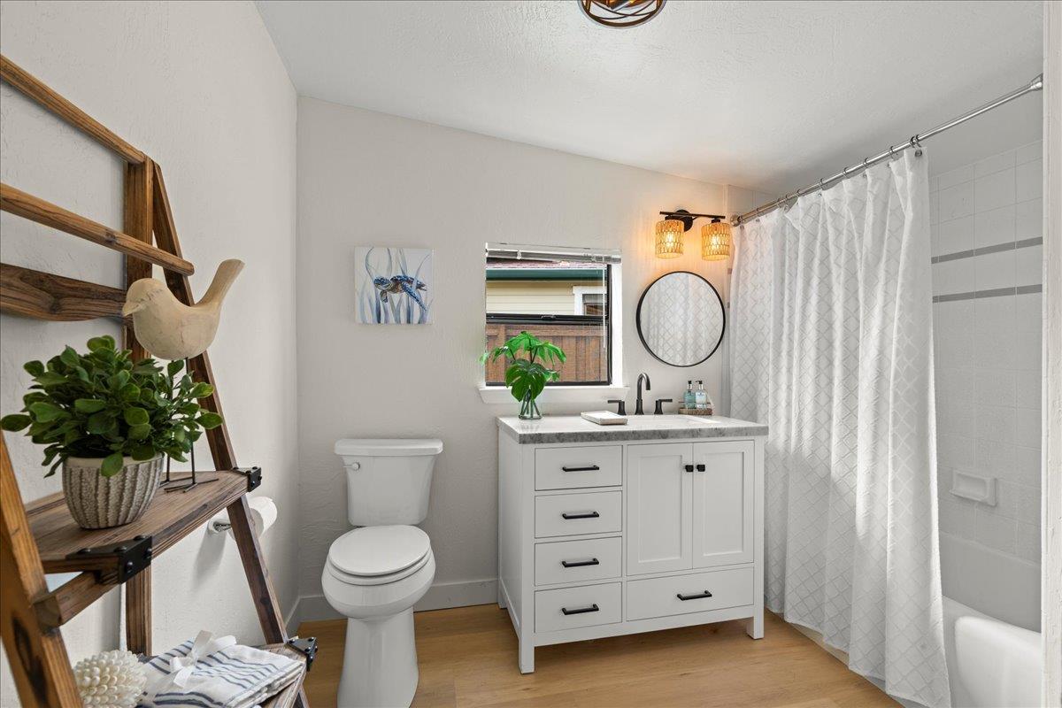 214 Rigg Street Santa Cruz, CA 95060 - Photo 20 of 32 a bathroom with a toilet a sink and a mirror