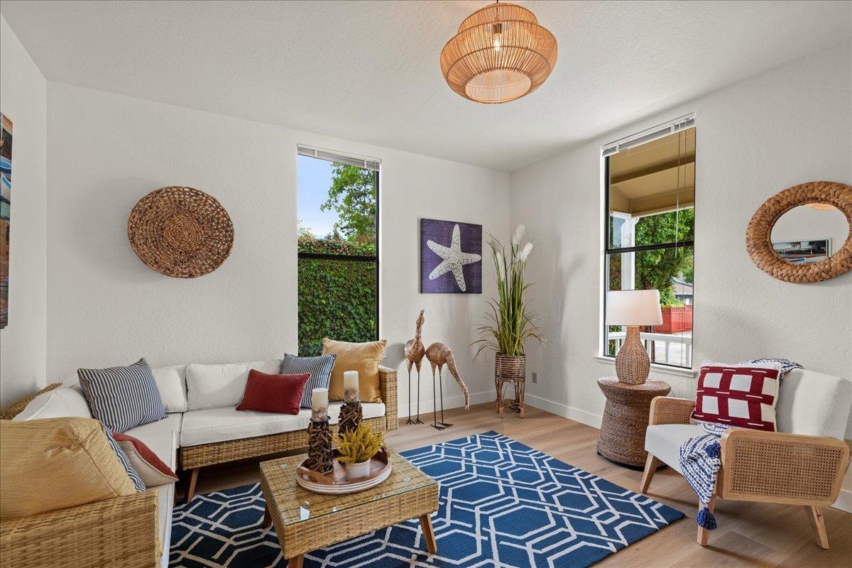 214 Rigg Street Santa Cruz, CA 95060 - Photo 7 of 32 a living room with furniture a rug and wall paintings