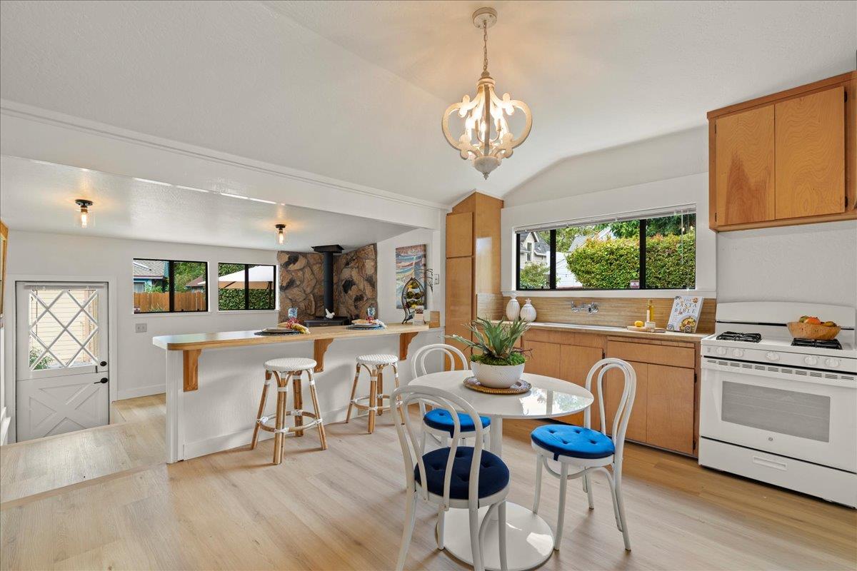 214 Rigg Street Santa Cruz, CA 95060 - Photo 9 of 32 a view of a dining room with furniture a chandelier and wooden floor