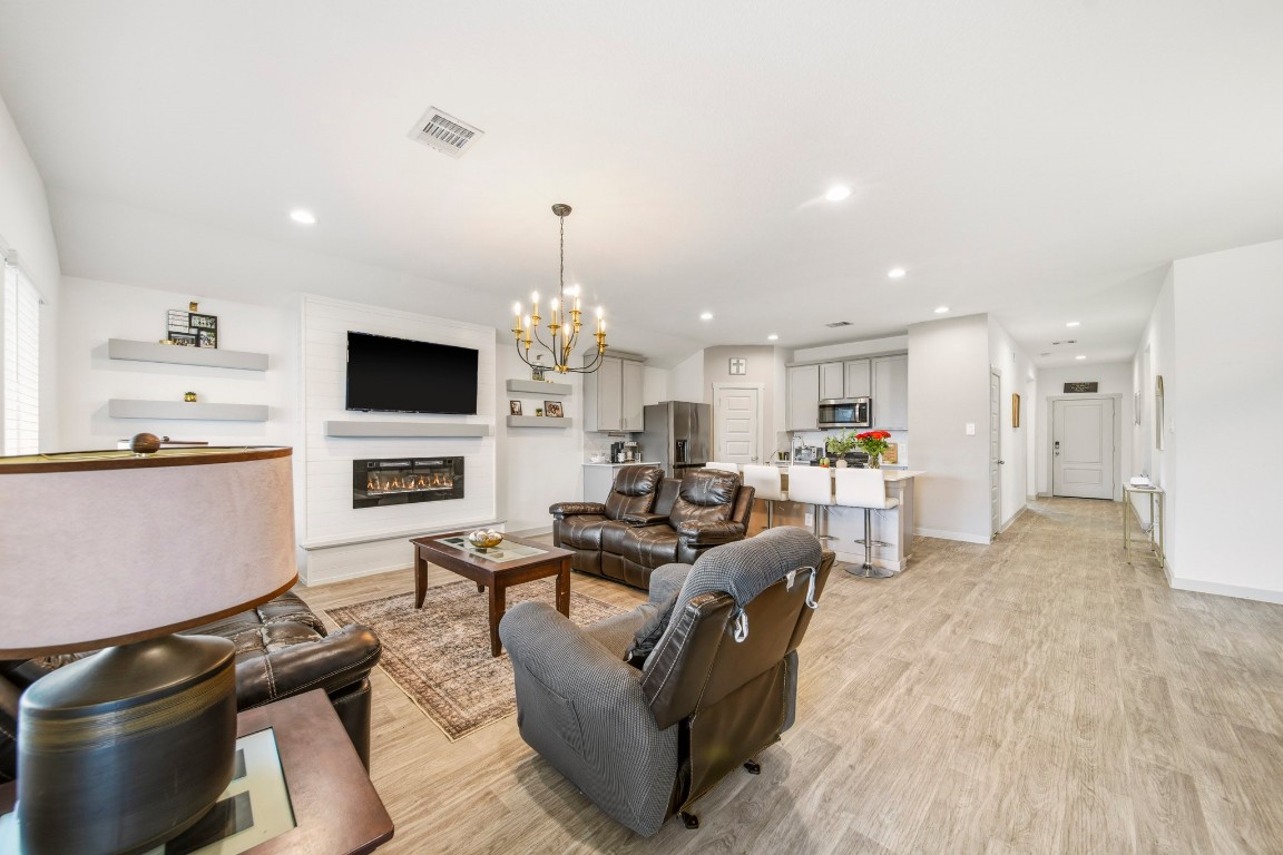 8210 Buck Lane Rosharon, TX 77583 - Photo 12 of 30 Open-concept living area with seamless flow between kitchen, dining, and seating spaces.