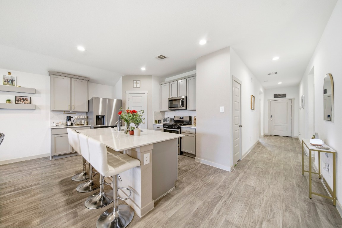 8210 Buck Lane Rosharon, TX 77583 - Photo 15 of 30 Open-concept kitchen featuring a large island with seating and seamless flow to the living areas.