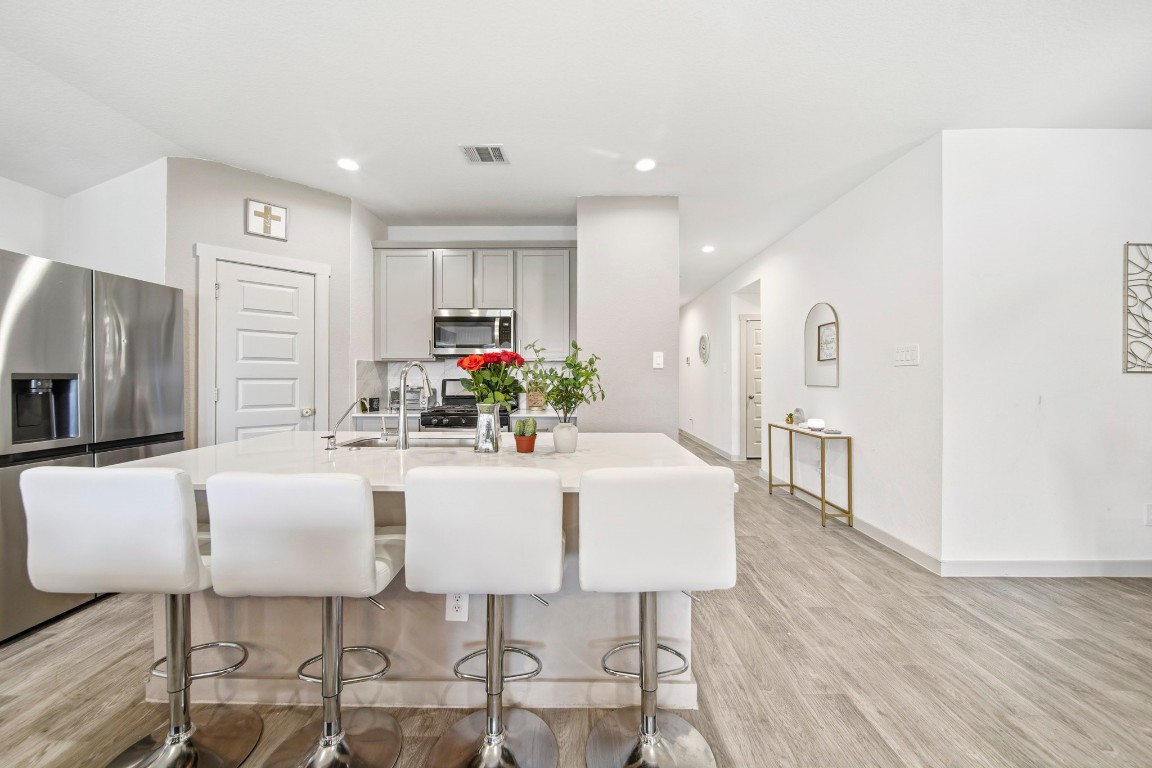 8210 Buck Lane Rosharon, TX 77583 - Photo 16 of 30 Open kitchen layout with a large island and bar seating overlooking the main living areas.