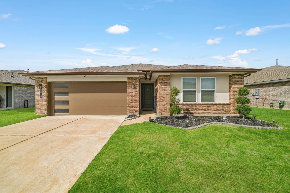 8210 Buck Lane Rosharon, TX 77583 - Photo 2 of 30 Wide driveway leading to a welcoming front entry with mature landscaping accents.