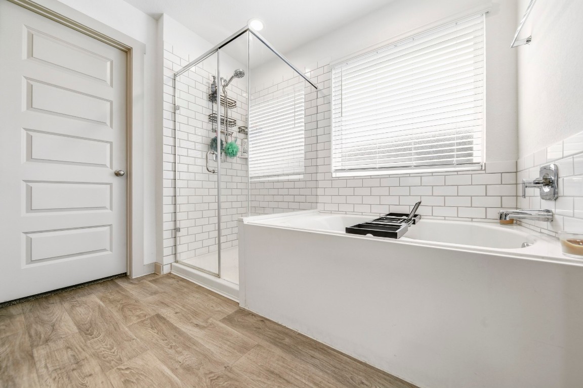 8210 Buck Lane Rosharon, TX 77583 - Photo 22 of 30 Elegant bathroom design with a separate tub and glass-enclosed shower.