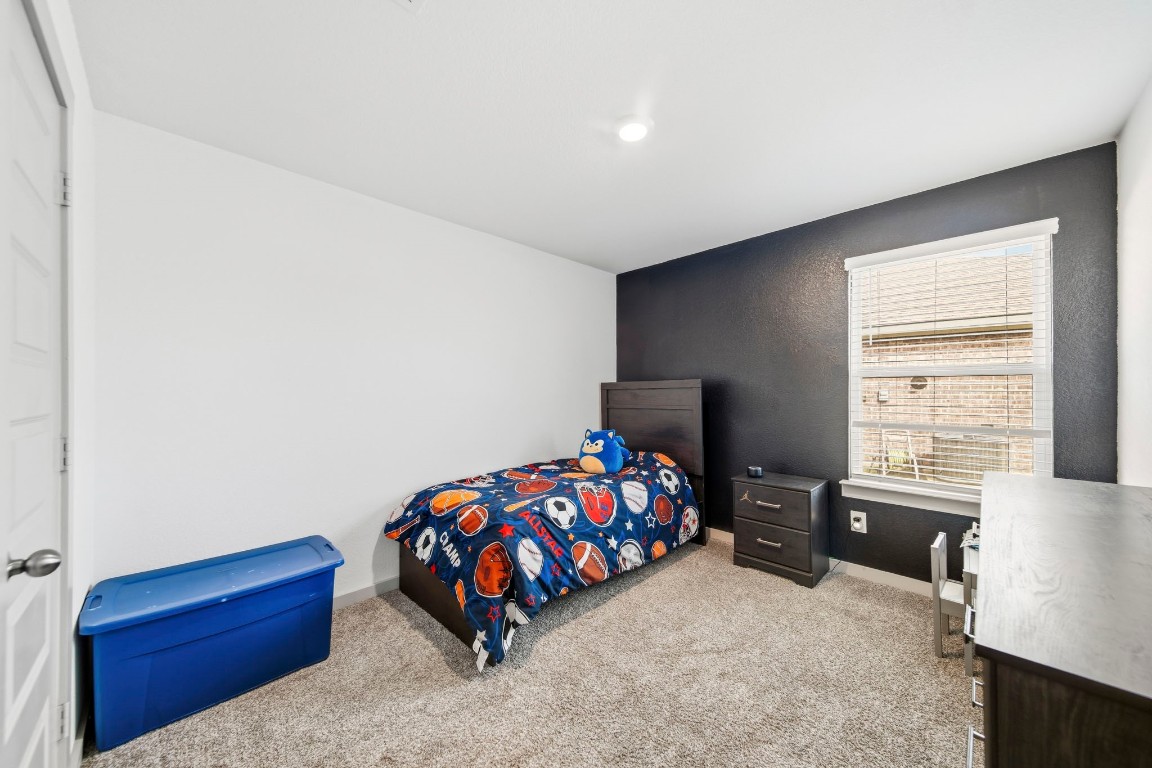 8210 Buck Lane Rosharon, TX 77583 - Photo 23 of 30 Cozy secondary bedroom with ample space for furniture and storage.